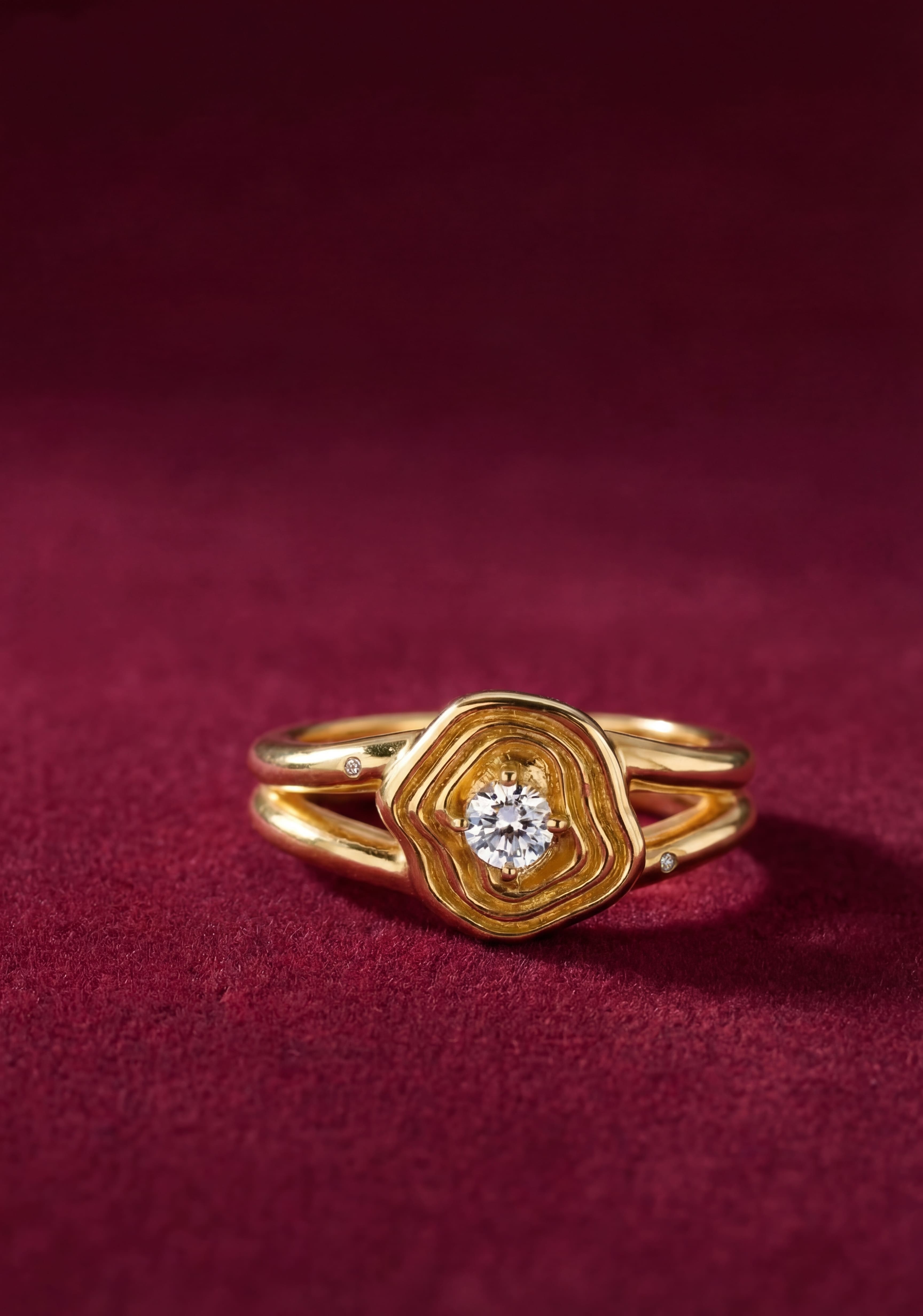 Gold ring with a diamond on a red fabric background