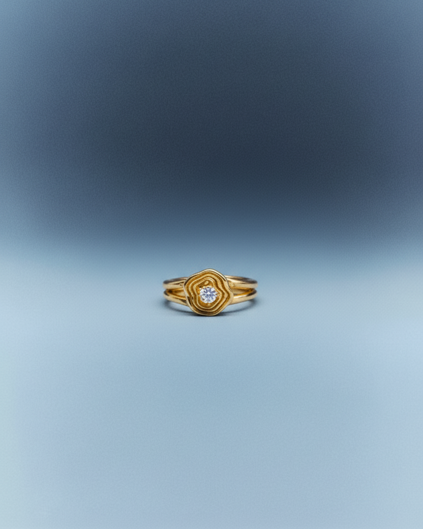 Gold ring with a diamond on a gradient blue background