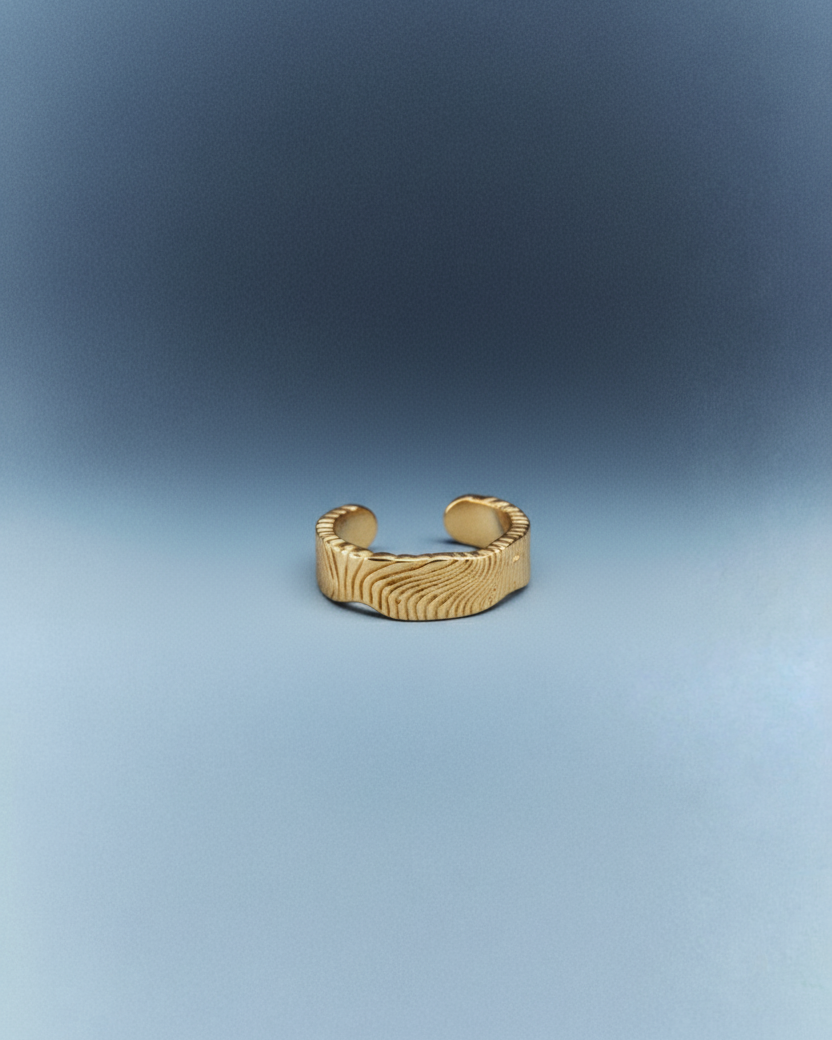 Gold bracelet on a blue gradient background